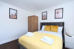 a bedroom with a bed with two towels on it at Open Mind Property - Ensuite Room Number 3 in Fareham