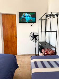 a bedroom with a bed and a fan and a door at Tu lugar de descanso III in Federación