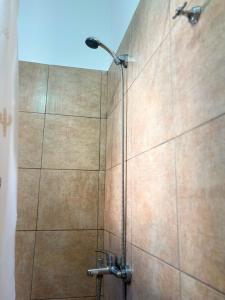 a shower with a shower head in a bathroom at Tu lugar de descanso III in Federación +7 photos