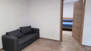a living room with a couch and a mirror at Apartma Nad Klancem in Most na Soči
