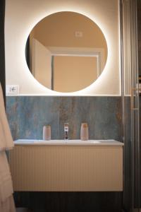 a bathroom with a sink and a mirror at King Rooms in Portoferraio +36 photos