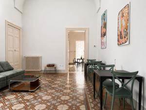 a living room with a couch and a table and chairs at Palazzo Vite in Copertino