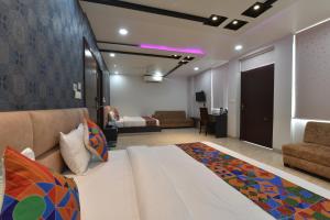a bedroom with a large bed and a living room at Hotel Pearl Heritage in Jaipur