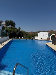 a large swimming pool with blue water at Marbella Sunseat apartment in Marbella