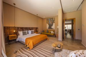 a bedroom with a large bed and a living room at PALAIS SOHAN in Marrakesh +66 photos