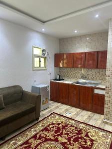 a living room with a couch and a kitchen at جوهرة عسير in Abha