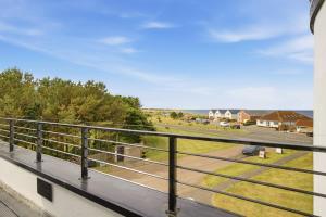 a balcony with a view of a park at Beadnell Point - North East Escapes in Beadnell
