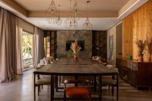 a dining room with a large wooden table and chairs at PALAIS SOHAN in Marrakesh