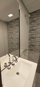 a bathroom with a white sink and a mirror at DG Rosa María in Santiago del Estero