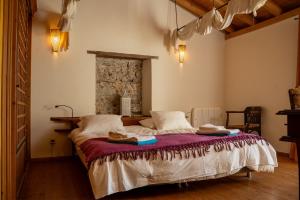 a bedroom with a bed with towels on it at Monte D´Sancho in Aljezur +100 photos