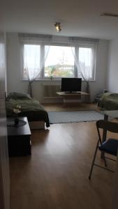 a bedroom with two beds and a flat screen tv at 35 Square meter Apartment in Sankt Pölten