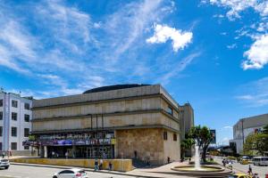 a building on a city street with a blue sky at Confortable apartaestudio in Manizales