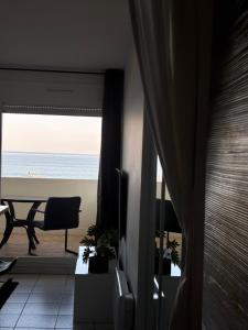 a room with a view of the ocean from a balcony at Le TAHITI in Frontignan