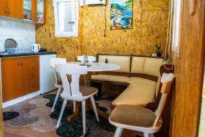 a kitchen with a table and chairs in a room at Lakeside Cabin in Jablanica