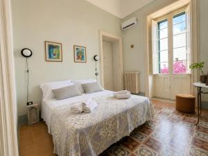 a bedroom with a bed with towels on it at Palazzo Vite in Copertino