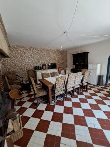 a dining room with a table and chairs at La Ferme de Tréfumel in Tréfumel