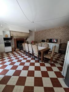a kitchen with a table and chairs in a room at La Ferme de Tréfumel in Tréfumel