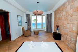 a room with a bed and a stone wall at Villa Kyma in Platána