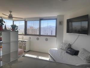 a living room with a couch and some windows at 123Eilat panorama in Eilat