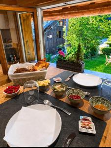 a table with plates and bowls of food on it at Chalet Lisa B&B in Morzine