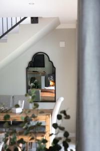 a mirror on the wall next to a staircase at Le Vaal Manor in Parys