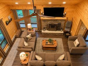 an overhead view of a living room with a fireplace at Clocked Out Cabin with Lake Access, Fire Pit, Games in Blakeslee