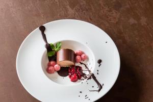 a white plate with chocolate desserts on a table at Hotel Schöpf - Mountain Hideaway in Längenfeld