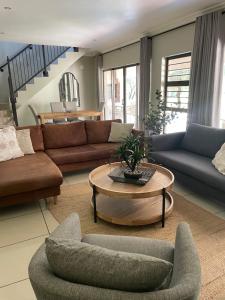 a living room with couches and a coffee table at Le Vaal Manor in Parys +56 photos