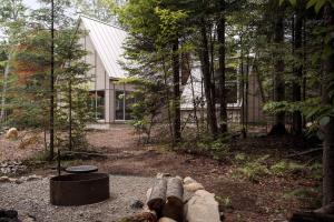 a pile of logs laying on the ground in front of a house at The Cape in Rawdon