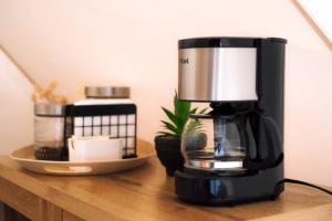 a coffee maker sitting on top of a wooden table at Glamping Rivera del Mar - RV Park in Loreto +11 photos