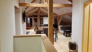 a living room with wooden beams and a dining room at Landhaus Hickman in Hopferau