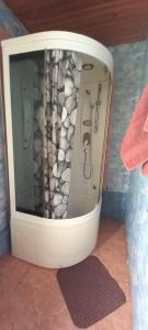 a bath tub with a shower in a bathroom at Kļūda1 in Biksinīki