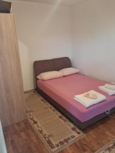 a bed in a room with a purple mattress at Bosiljak in Zelenika
