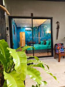 a living room with a large glass window and a couch at Green Valley Lodge in Khao Sok National Park +38 photos