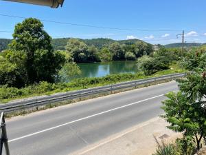 a road next to a river with a bridge at MiR in Londža