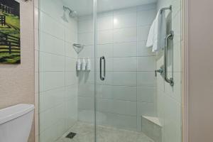 a shower with a glass door in a bathroom at Louisville Marriott East in Louisville