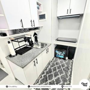 a small kitchen with a sink and a counter at Blanc Suite in Roxas City