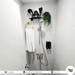 a bathroom with a shower with two monkeys on a shelf at Blanc Suite in Roxas City +4 photos