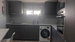 a kitchen with a washing machine and a sink at Casa Alentejana in Mora +24 photos