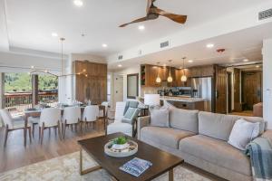 a living room and kitchen with a couch and a table at Condos at Canyons Resort by White Pines in Park City
