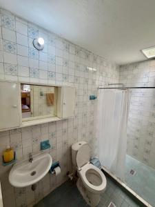 a bathroom with a toilet and a sink at Hostal Beko in Cali +29 photos