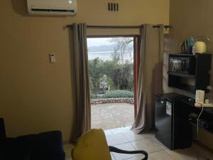 a living room with a sliding glass door at Mafofolozi Lodge in Hartbeespoort