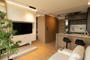 a living room with a large flat screen tv at Modern, Fully Equipped and Cozy Loft in Cali