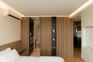 a bedroom with a bed and a closet at Modern, Fully Equipped and Cozy Loft in Cali +23 photos