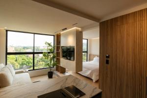 a bedroom with a bed and a large window at Modern, Fully Equipped and Cozy Loft in Cali
