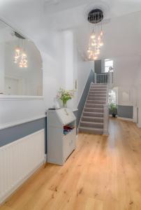 a living room with a staircase and a mirror at The Montana in Torquay