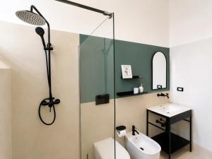 a bathroom with a shower and a toilet and a sink at Palazzo Vite in Copertino +88 photos