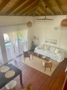 a living room with a white couch and a table at HOLBOX PUERTA DEL MAR in Holbox Island