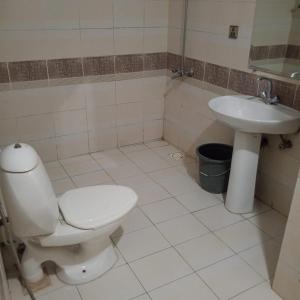 a bathroom with a toilet and a sink at Sunset Lodges Bhurban in Bhurban
