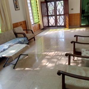 a living room with a couch and chairs in it at Sunset Lodges Bhurban in Bhurban